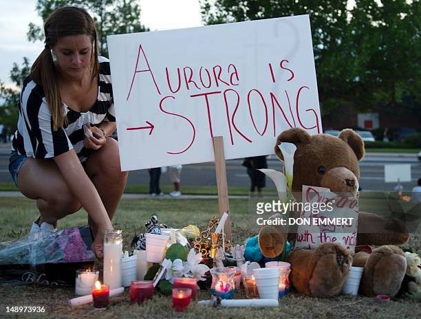 Mourners at a vigil light candles near theater where 12 people were killed July 20, 2012 in Aurora, Colorado. A graduate student who told police he...
