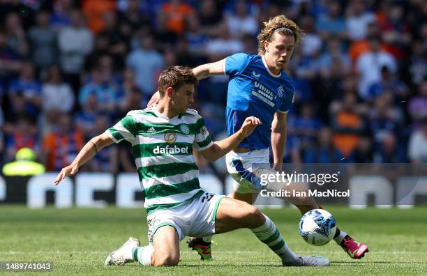 Matt O'Riley of Celtic is challenged by Todd Cantwell of Rangers FC during the Cinch Premiership match between Rangers and Celtic at Ibrox Stadium on...