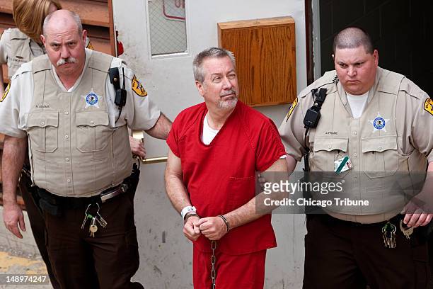 Drew Peterson, pictured in this 2009 file photo, is escorted out of the Will County Courthouse in Joliet, Illinois. Eight years after nursing student...