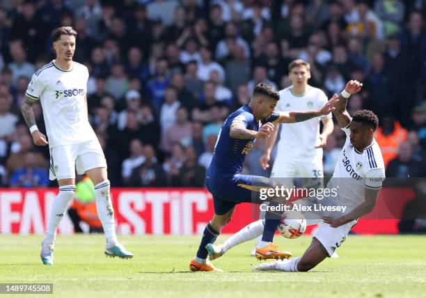 Junior Firpo of Leeds United fouls Bruno Guimaraes of Newcastle United during the Premier League match between Leeds United and Newcastle United at...