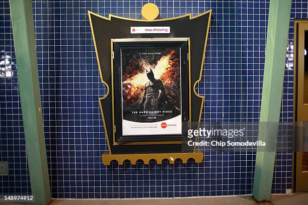 Movie poster hangs in a decorative frame outside the AMC Arapahoe Crossing 16 movie theater July 20, 2012 in Aurora, Colorado. The AMC Arapahoe...
