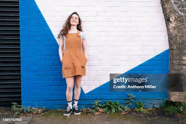 young woman in front of two toned wall - two tone color stock pictures, royalty-free photos & images