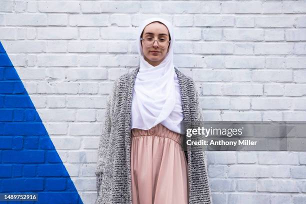 young woman in front of two toned wall - two tone color stock pictures, royalty-free photos & images