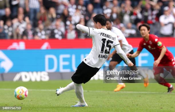 Daichi Kamada of Eintracht Frankfurt scores the team's first goal from the penalty spot during the Bundesliga match between Eintracht Frankfurt and...
