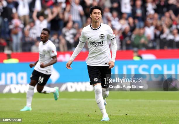 Daichi Kamada of Eintracht Frankfurt celebrates after scoring the team's first goal from the penalty spot during the Bundesliga match between...