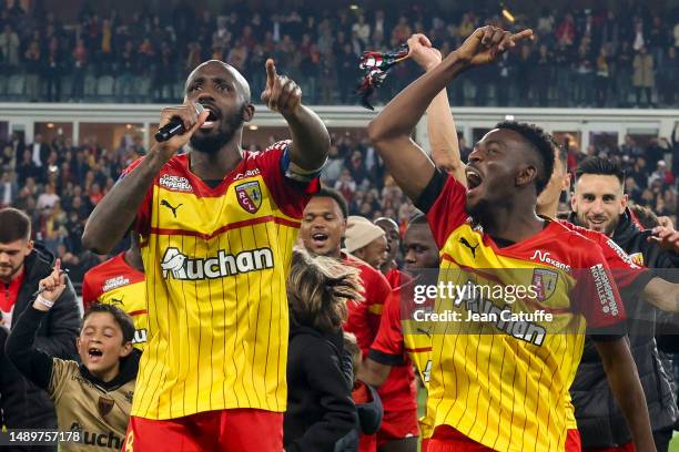 Captain Seko Fofana - holding the mic -, Salis Abdul Samed of Lens and teammates celebrate the victory following the Ligue 1 Uber Eats match between...