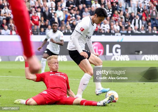 Daichi Kamada of Eintracht Frankfurt is fouled by Andreas Hanche-Olsen of 1.FSV Mainz 05 which leads to a penalty to Eintracht Frankfurt during the...