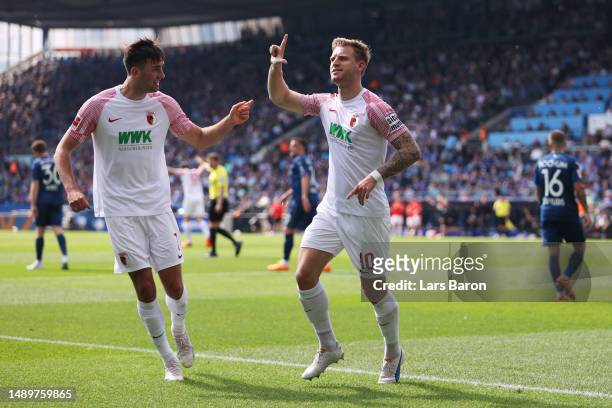 Arne Maier of FC Augsburg celebrates with teammate Dion Beljo after scoring the team's first goal during the Bundesliga match between VfL Bochum 1848...