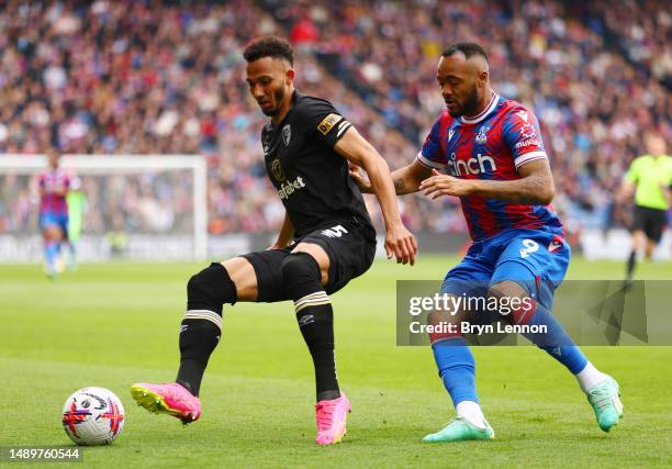 Lloyd Kelly of AFC Bournemouth controls the ball whilst under pressure from Jordan Ayew of Crystal Palace during the Premier League match between...