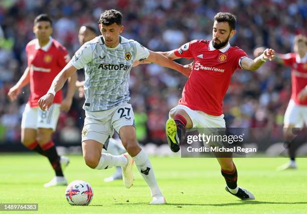 Matheus Nunes of Wolverhampton Wanderers is challenged by Bruno Fernandes of Manchester United during the Premier League match between Manchester...
