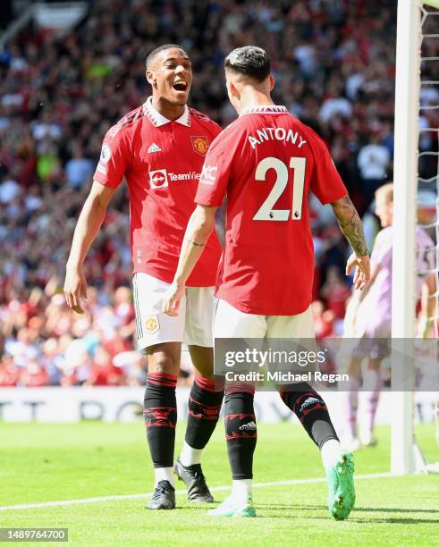 Anthony Martial of Manchester United celebrates after scoring the team's first goal with teammates Antony during the Premier League match between...