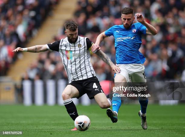 Kyle Cameron of Notts County is challenged by Ryan Colclough of Chesterfield during the Vanarama National League Play-Off Final match between...