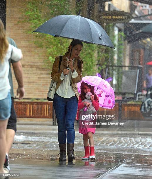 Katie Holmes and Suri Cruise seen walking in the rain in the Meat Packing District on July 20, 2012 in New York City.