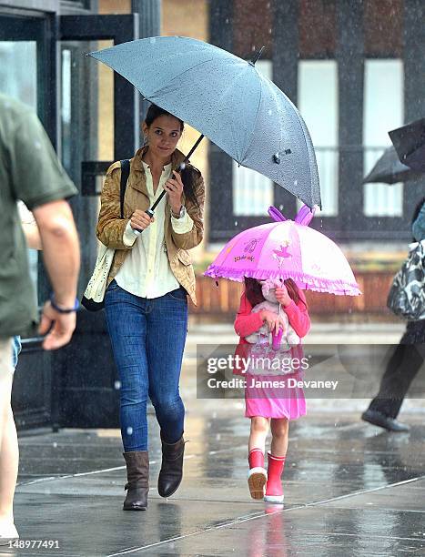 Katie Holmes and Suri Cruise seen walking in the rain in the Meat Packing District on July 20, 2012 in New York City.