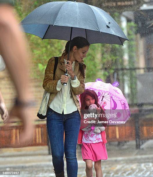 Katie Holmes and Suri Cruise seen walking in the rain in the Meat Packing District on July 20, 2012 in New York City.