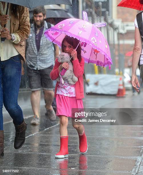 Suri Cruise seen walking in the rain in Chelsea on July 20, 2012 in New York City.