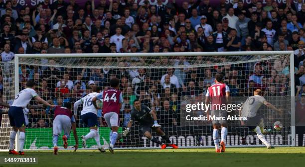 Harry Kane of Tottenham Hotspur scores the team's first goal from the penalty spot during the Premier League match between Aston Villa and Tottenham...