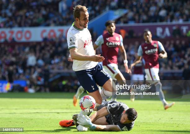Harry Kane of Tottenham Hotspur is challenged by Emiliano Martinez of Aston Villa which leads to a Tottenham Hotspur penalty during the Premier...