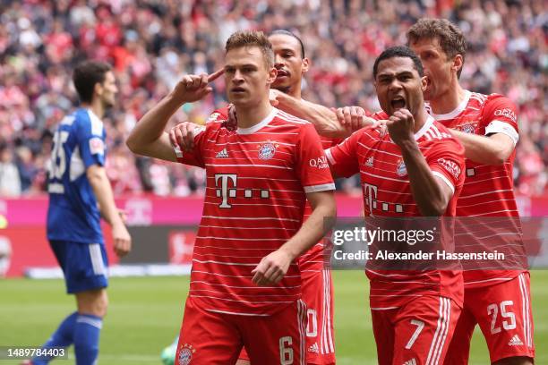 Joshua Kimmich of FC Bayern Munich celebrates with teammates Leroy Sane, Thomas Müller and Serge Gnabry after scoring the team's second goal during...