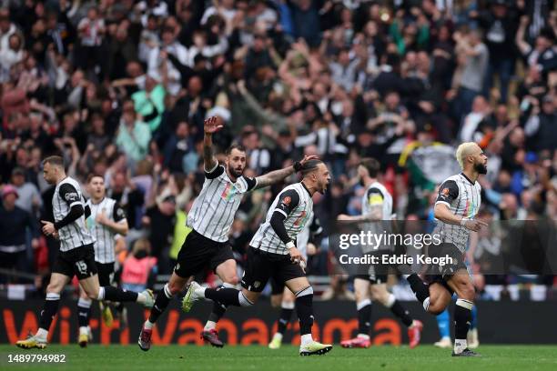 John Bostock of Notts County celebrates after scoring the team's first goal with teammates Jodi Jones and Connell Rawlinson during the Vanarama...