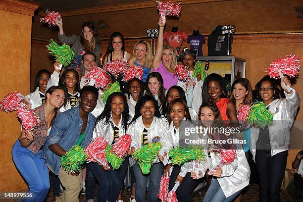 Members of the 2012 UCA National High School Cheerleading Champions from Burlington Township High School pose backstage with the cast at the hit...
