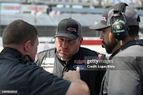 Ryan Newman, driver of the Biohaven/Jacob Co. Ford, meets with crew members during qualifying for the NASCAR Cup Series Goodyear 400 at Darlington...
