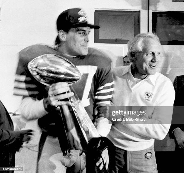 San Francisco 49ers Head Coach Bill Walsh and WR Dwight Clark celebrate victory with Vince Lombardi Trophy after Super Bowl XIX win over Miami...