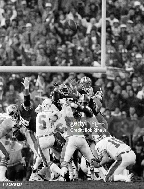 San Francisco QB Don Strock holds as Uwe von Schamann kicks a Field Goal during game action at Super Bowl XIX of Miami Dolphins vs. San Francisco...