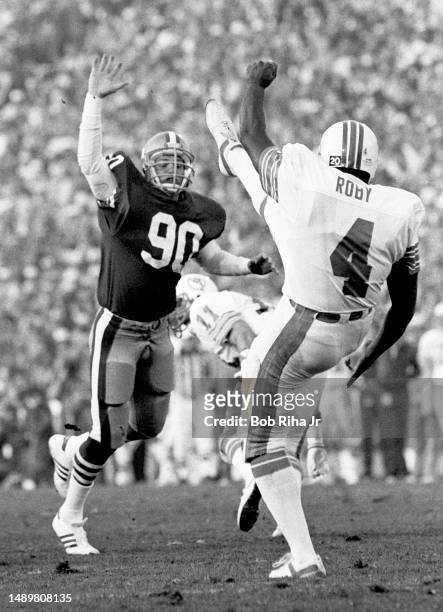 San Francisco Todd Shell attempts to block a punt by Dolphins punter Reggie Roby during game action at Super Bowl XIX of Miami Dolphins vs. San...