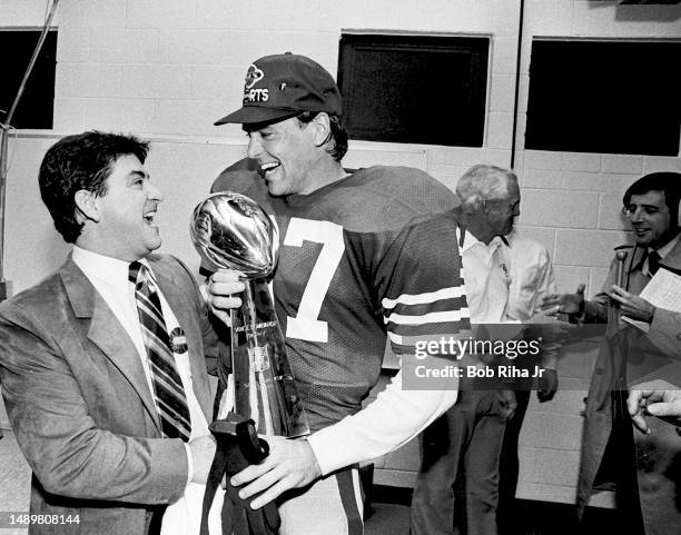 San Francisco 49ers Owner Eddie DeBartolo Jr. Celebrates win with WR Dwight Clark and Vince Lombardi Trophy after Super Bowl XIX win over Miami...