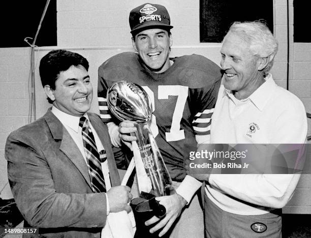 San Francisco 49ers Owner Eddie DeBartolo Jr. , WR Dwight Clark and Head Coach Bill Walsh celebrate victory with Vince Lombardi Trophy after Super...