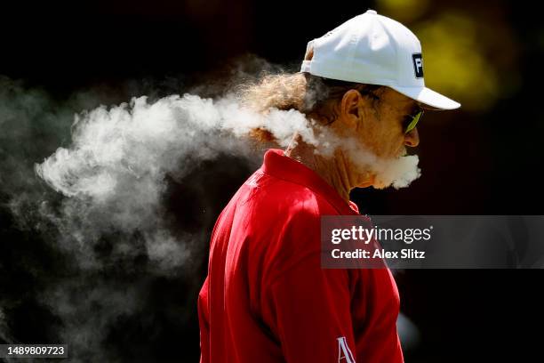 Miguel Angel Jiménez of Spain exhales cigar smoke on the second hole during the third round of the Regions Tradition at Greystone Golf and Country...