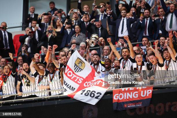 Kyle Cameron of Notts County lifts the National League Play-Off Final Trophy as players of Notts County celebrate after defeating Chesterfield in a...