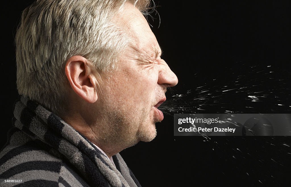 Man with flu coughing and sneezing