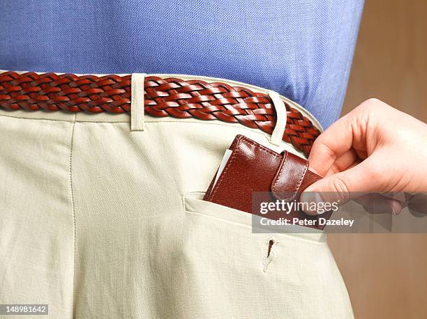 hand removing the wallet from a man's pocket - back pocket photos et images de collection