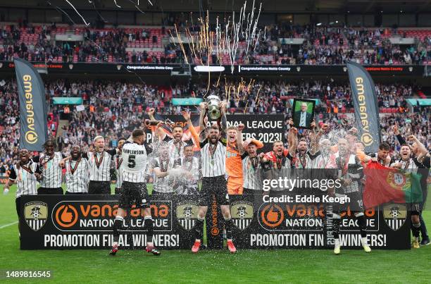 Kyle Cameron of Notts County lifts the National League Play-Off Final Trophy as players of Notts County celebrate after defeating Chesterfield in a...