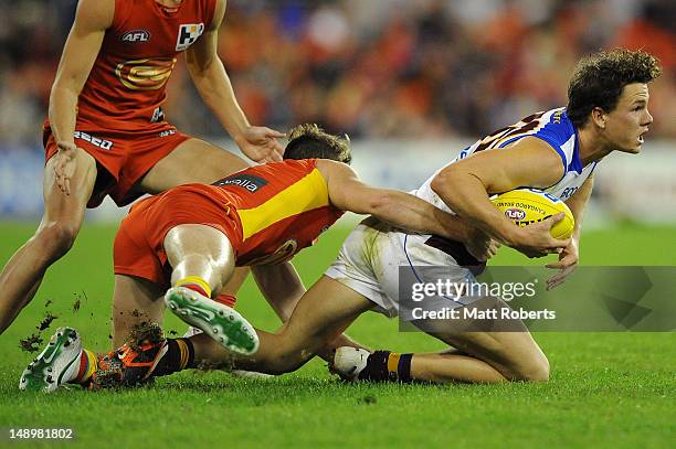 Jack Reed of the Lions is tackled during the round 17 AFL match between the Gold Coast Suns and the Brisbane Lions at Metricon Stadium on July 21,...