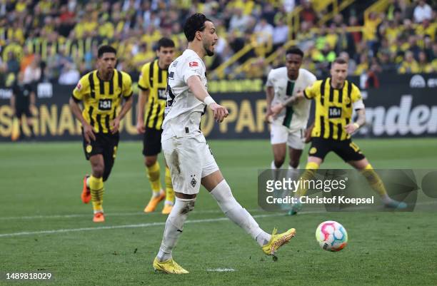 Ramy Bensebaini of Borussia Moenchengladbach scores the team's first goal after a penalty during the Bundesliga match between Borussia Dortmund and...