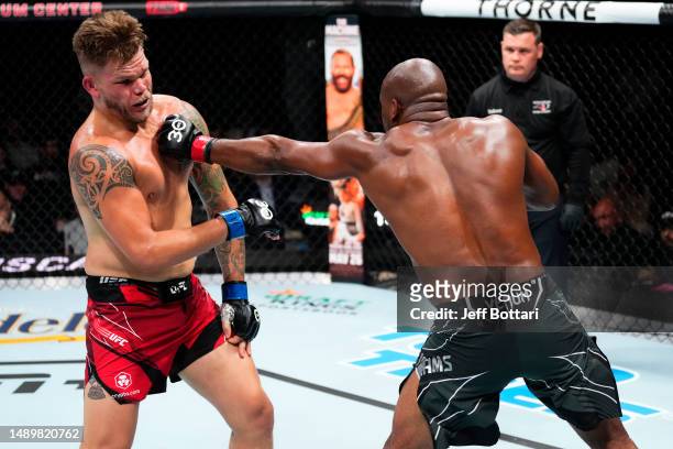 Karl Williams of the U.S. Virgin Islands punches Chase Sherman in their heavyweight fight during the UFC Fight Night event at Spectrum Center on May...