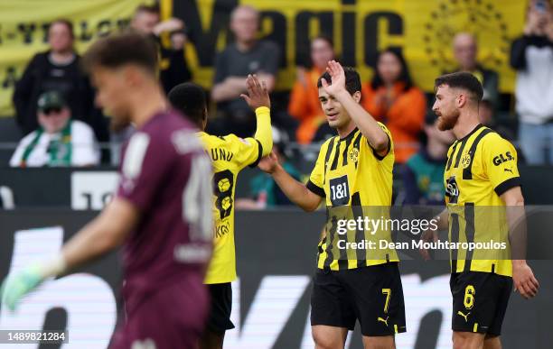 Giovanni Reyna of Borussia Dortmund celebrates with teammates after scoring the team's fifth goal during the Bundesliga match between Borussia...