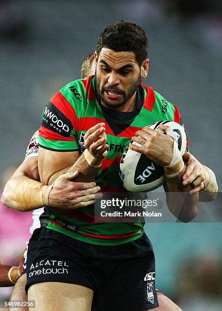 Nolan Stringer Greg Inglis of the Rabbitohs is tackled during the round 20 NRL match ...