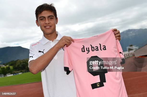 Paulo Dybala shows his new shirt during his presentation as the club's new signing, after a US Citta di Palermo pre-season training session at Sport...