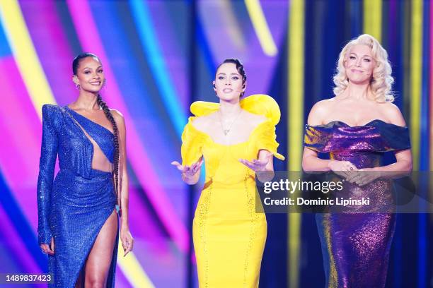 Eurovision hosts Alesha Dixon, Julia Sanina and Hannah Waddingham on stage during The Eurovision Song Contest 2023 Grand Final at M&S Bank Arena on...