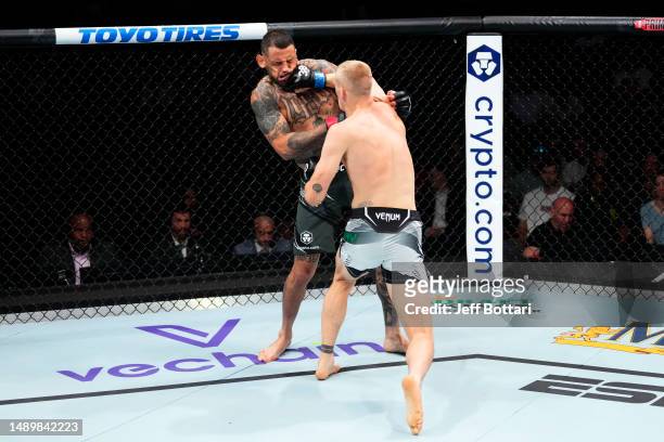 Ian Garry of Ireland punches Daniel Rodriguez in their welterweight fight during the UFC Fight Night event at Spectrum Center on May 13, 2023 in...