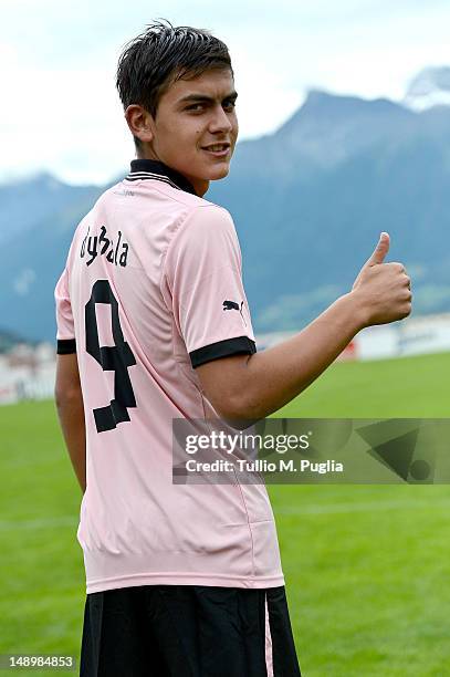 Paulo Dybala wears his new shirt during his presentation as the club's new signing after a US Citta di Palermo pre-season training session at Sport...