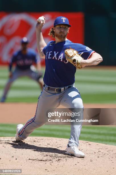 Jon Gray of the Texas Rangers pitches in the bottom of the first inning against the Oakland Athletics at RingCentral Coliseum on May 13, 2023 in...