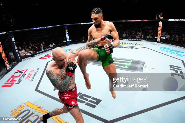 Johnny Walker of Brazil knees Anthony Smith in their light heavyweight fight during the UFC Fight Night event at Spectrum Center on May 13, 2023 in...