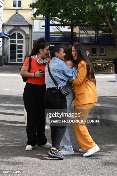 Students react after viewing the results of the baccalaureat exam , on July 4, 2023 at the Pasteur high school in Strasbourg, eastern France.