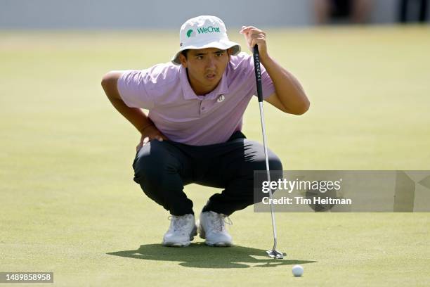 Zecheng Dou of China lines up a putt on the 18th green during the third round of the AT&T Byron Nelson at TPC Craig Ranch on May 13, 2023 in...