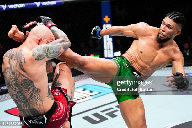 Johnny Walker of Brazil kicks Anthony Smith in their light heavyweight fight during the UFC Fight Night event at Spectrum Center on May 13, 2023 in...